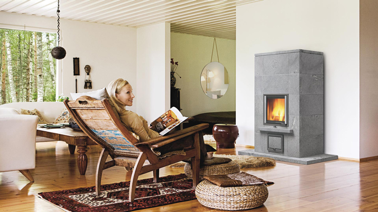 Woman sitting on a chair next to the fireplace